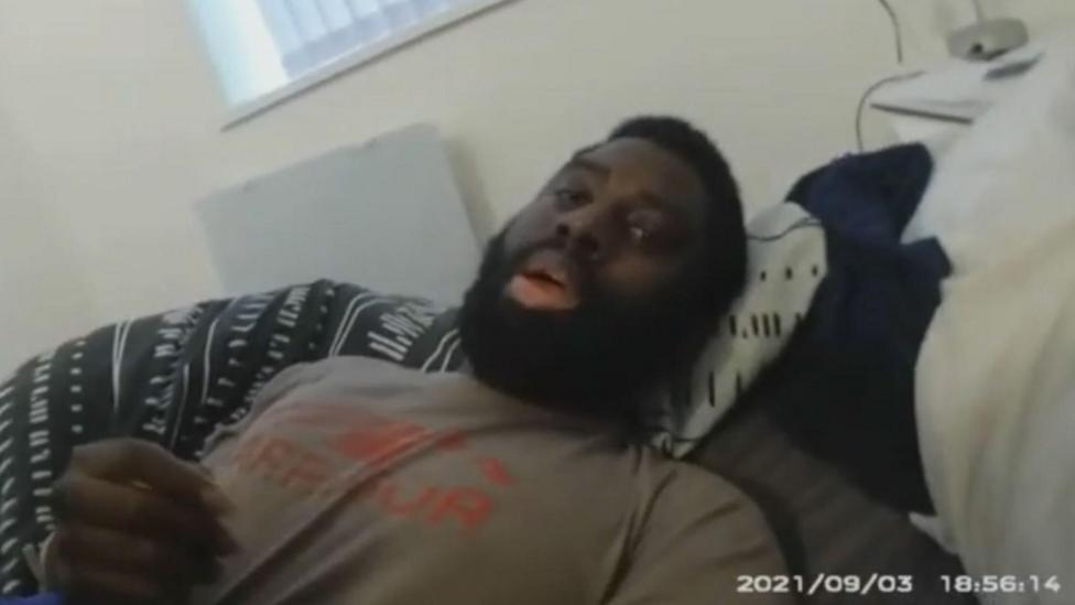 Valdo Calocane being restrained on a bed in his flat by police during a section 135 warrant under the mental health act in September 2021. The image has been taken from police body-worn camera footage dated 3 September 2021.