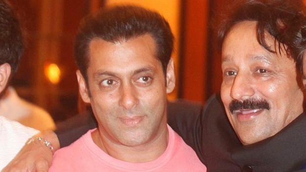 Congress MLA Baba Siddique, left, wearing a black suit, has his arm around with Bollywood actor Salman Khan, smiling while wearing a pink T-shirt